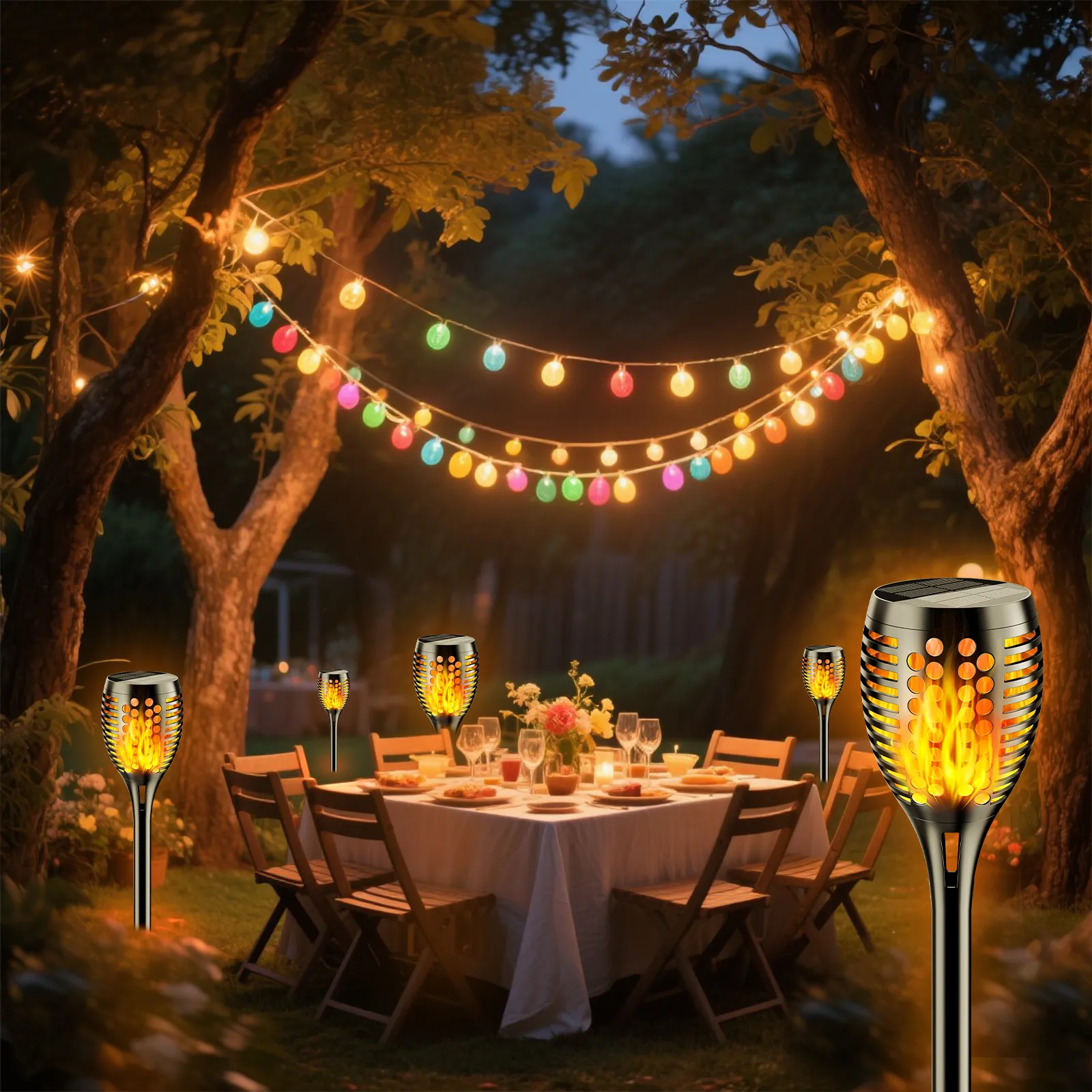 Decorative solar torch lights with flickering flame effect illuminating a garden pathway at dusk.