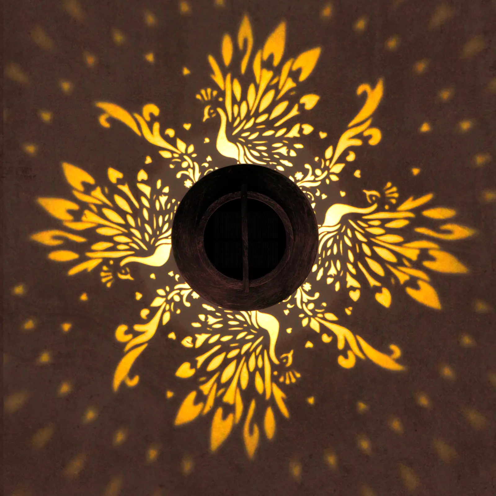 close‑up view of delicate peacock pattern projection from bronze solar lantern.