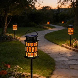 honeycomb solar flame lanterns lining garden stone path, flickering fire lights decorate backyard.