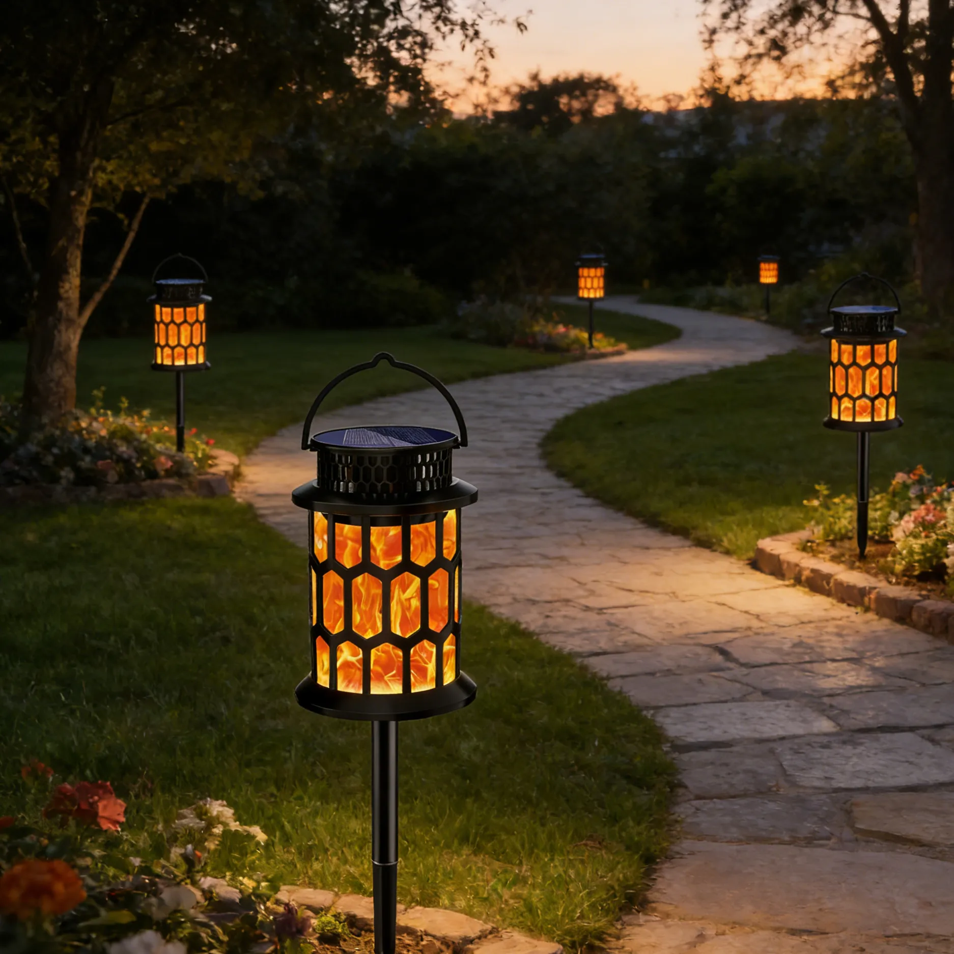 honeycomb solar flame lanterns lining garden stone path, flickering fire lights decorate backyard.
