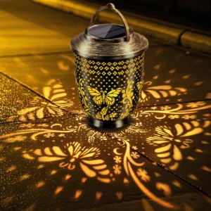 vintage bronze solar projection lantern, butterfly floral pattern casting warm light.